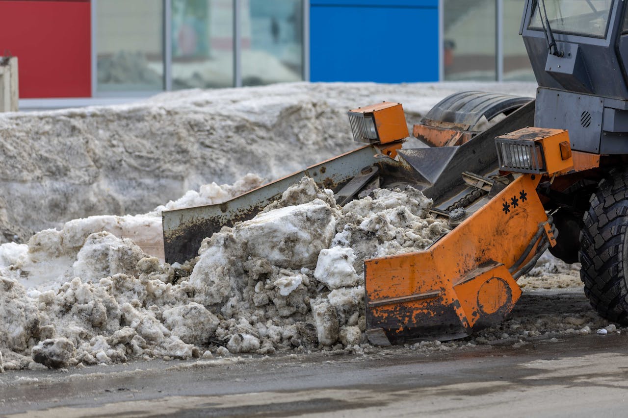 hero-img Heavy bulldozer clearing snow from urban area, showcasing powerful industrial machinery in action.